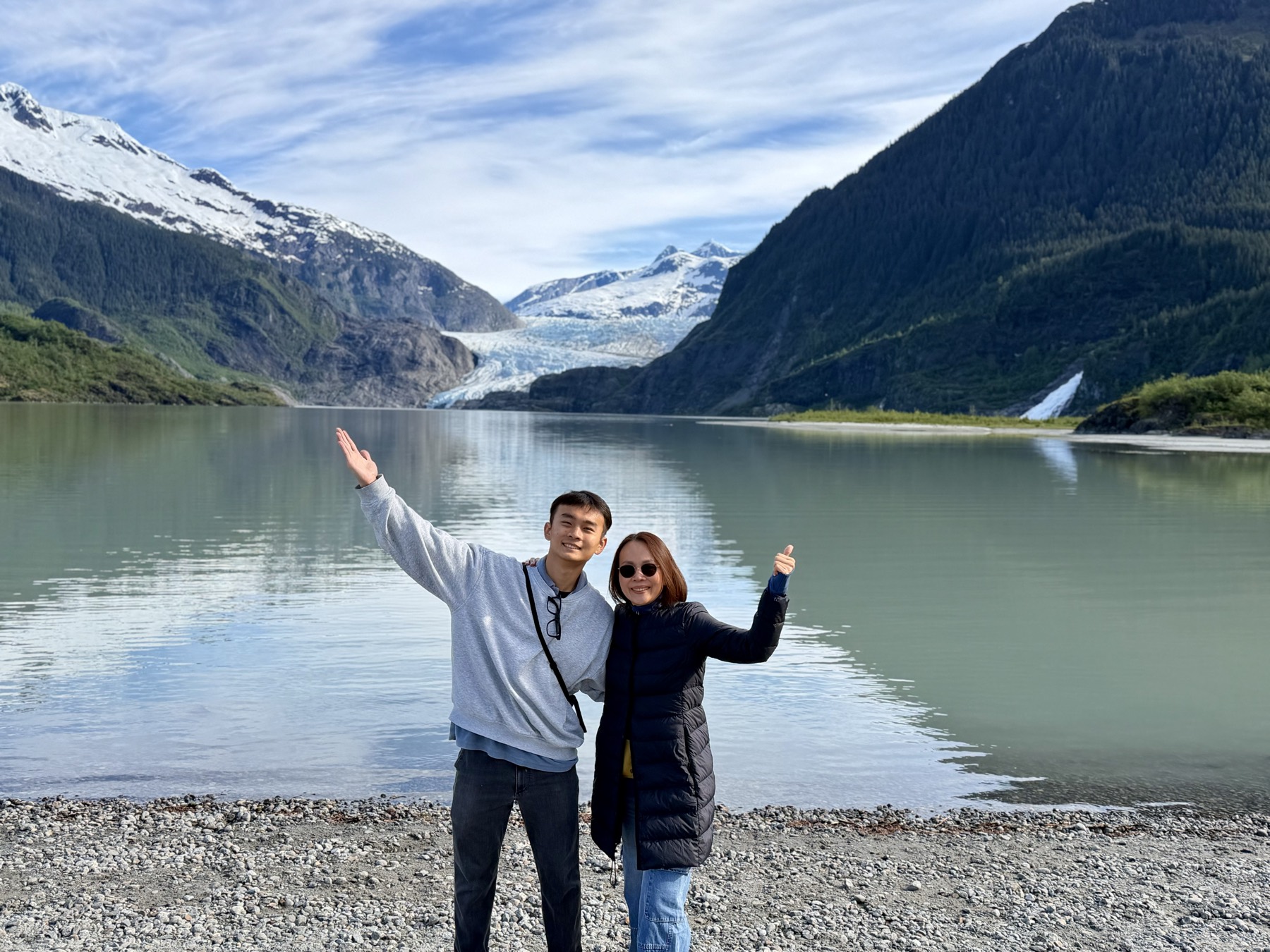 Harrison and his mom at Mendenhall Glacier in Alaska, arms raised